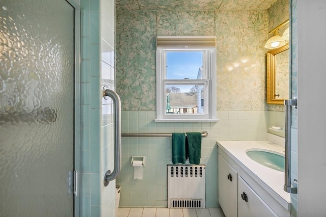 100 S Fairview Ave, Montauk, NY 11954 - bathroom featuring a wainscoted wall, wallpapered walls, vanity, a stall shower, and radiator