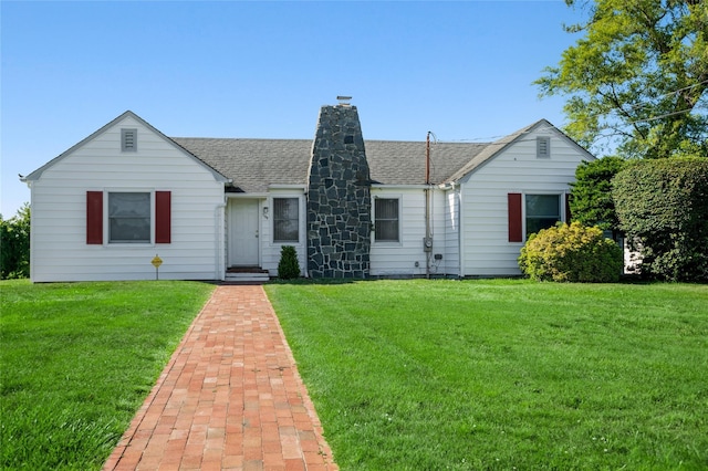100 S Fairview Ave, Montauk, NY 11954 - view of front of property with a front lawn, a chimney, and a shingled roof