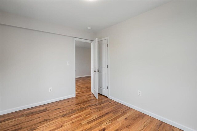 59-30 108th St Unit 6D, Corona, NY 11368 - empty room with light wood-style flooring and baseboards