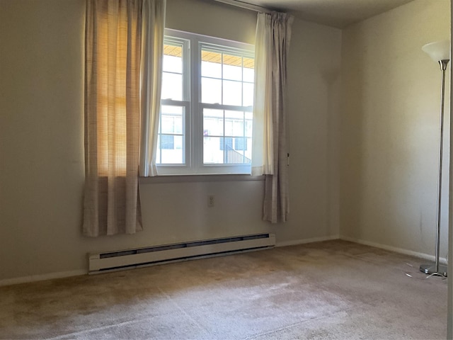 carpeted empty room with baseboards and a baseboard radiator