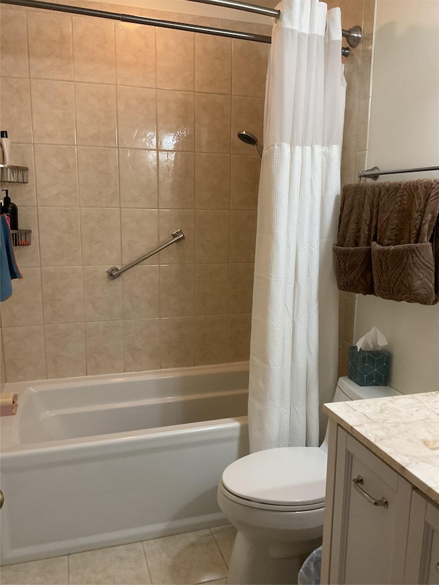 full bathroom featuring toilet, vanity, tile patterned floors, and shower / bath combo with shower curtain