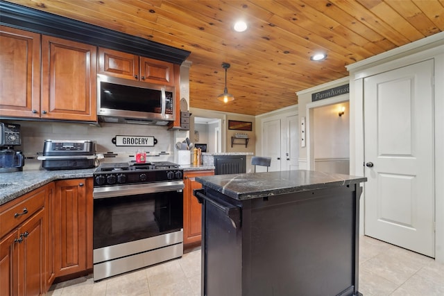 160 Mill St, Wallkill, NY 12589 - kitchen featuring appliances with stainless steel finishes, light tile patterned floors, wood ceiling, brown cabinetry, and a center island