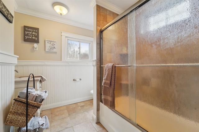 160 Mill St, Wallkill, NY 12589 - bathroom with ornamental molding, combined bath / shower with glass door, toilet, tile patterned flooring, and a wainscoted wall