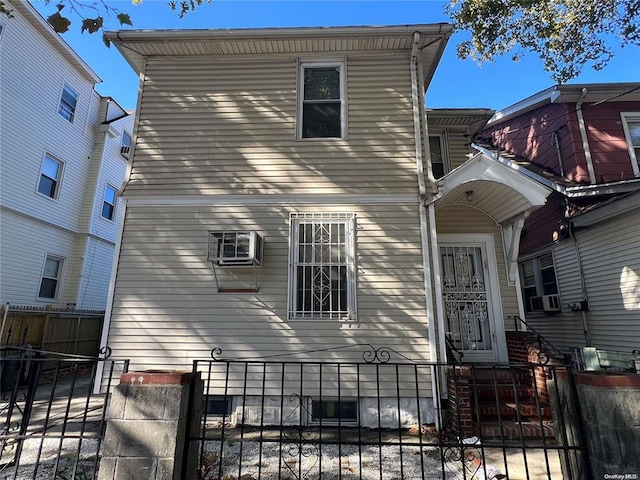 40-36 69th St, Woodside, NY 11377 - exterior space with a wall mounted air conditioner, a gate, cooling unit, and a fenced front yard