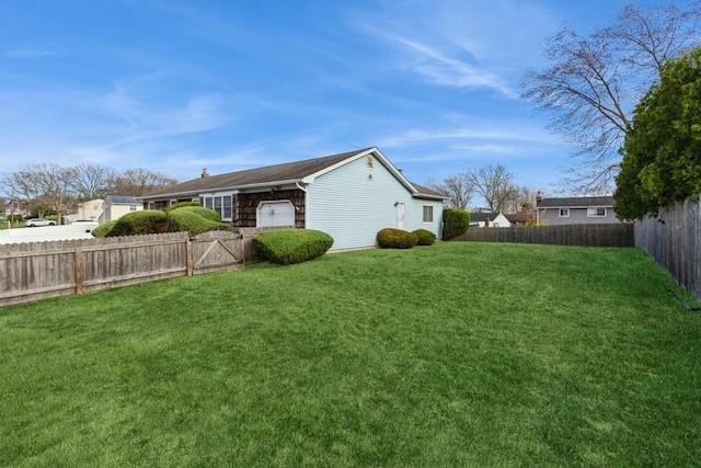 view of yard with a fenced backyard
