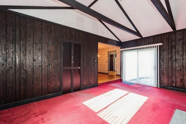 unfurnished room featuring high vaulted ceiling, wood walls, beam ceiling, and carpet floors