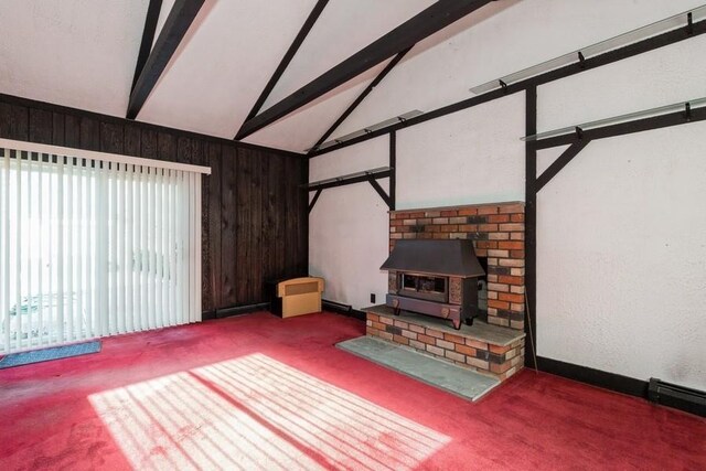 living room with lofted ceiling with beams, a wood stove, carpet floors, wood walls, and a baseboard heating unit