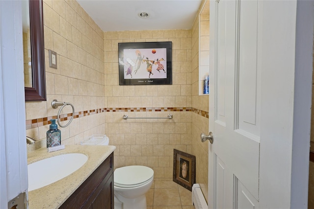 28 Winfield Davis Dr, Coram, NY 11727 - half bathroom featuring a baseboard radiator, vanity, tile walls, and tile patterned flooring