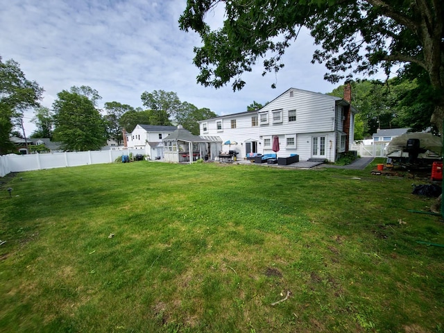 28 Winfield Davis Dr, Coram, NY 11727 - rear view of property featuring a chimney, outdoor lounge area, and a fenced backyard