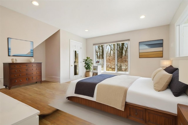 bedroom with recessed lighting, light wood-type flooring, and baseboards