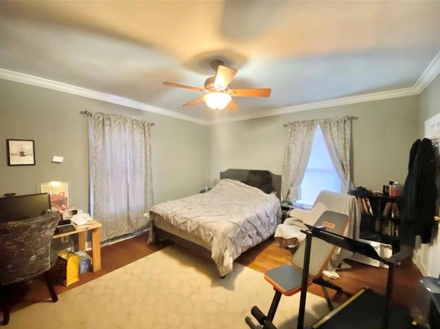 bedroom featuring wood finished floors, ceiling fan, and ornamental molding