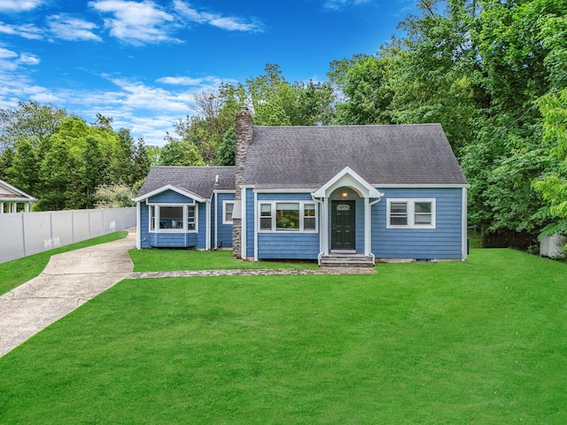 6 Youngs Ln, Setauket, NY 11733 - view of front of house featuring concrete driveway, a chimney, and a shingled roof