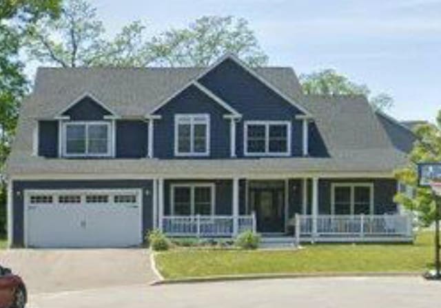 9 Saber Ln, Kings Park, NY 11754 - view of front of house with covered porch, a garage, and concrete driveway