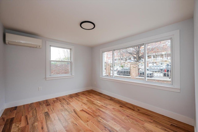 2738 Miles Ave, Bronx, NY 10465 - empty room with light wood finished floors, baseboards, and an AC wall unit