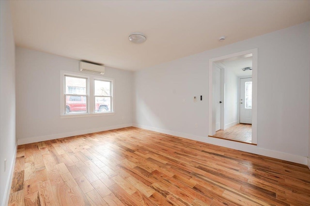 2738 Miles Ave, Bronx, NY 10465 - spare room featuring a wall unit AC, baseboards, and light wood finished floors