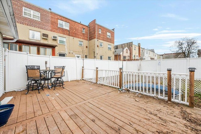 2738 Miles Ave, Bronx, NY 10465 - wooden deck featuring a fenced backyard and outdoor dining space