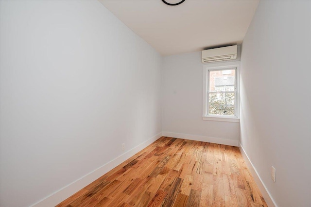 2738 Miles Ave, Bronx, NY 10465 - empty room with light wood-style floors, baseboards, and a wall mounted air conditioner