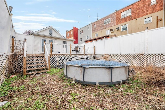 2738 Miles Ave, Bronx, NY 10465 - view of yard featuring fence, a wooden deck, and an outdoor pool