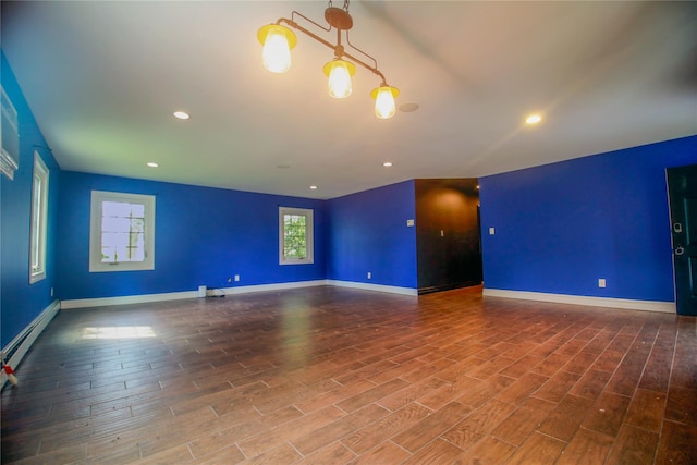 5 Millstream Ln, Stony Brook, NY 11790 - unfurnished room featuring a baseboard heating unit, wood finished floors, baseboards, and recessed lighting