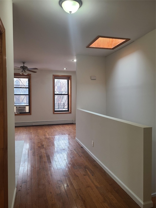 1871 Prospect Pl, Brooklyn, NY 11233 - spare room featuring plenty of natural light, baseboards, baseboard heating, and hardwood / wood-style floors