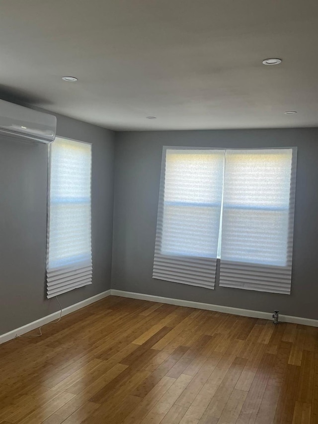 1871 Prospect Pl, Brooklyn, NY 11233 - empty room featuring baseboards, wood finished floors, and an AC wall unit
