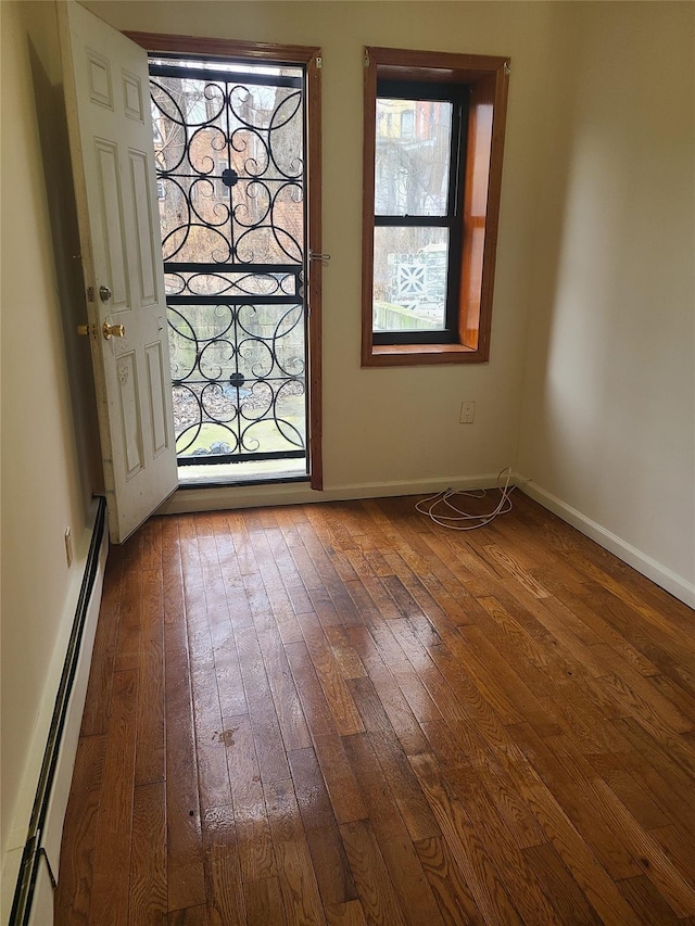 1871 Prospect Pl, Brooklyn, NY 11233 - foyer entrance with baseboards, baseboard heating, and wood-type flooring