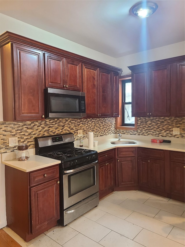 1871 Prospect Pl, Brooklyn, NY 11233 - kitchen with backsplash, light countertops, a sink, and appliances with stainless steel finishes