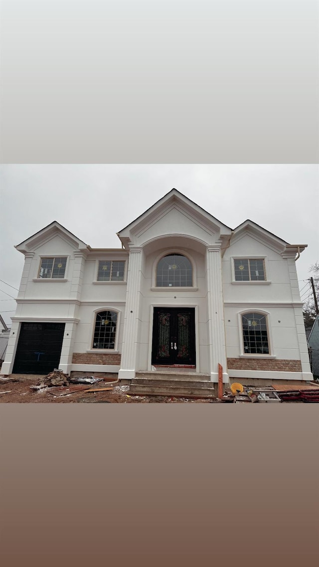 23 Grouse Ln, Levittown, NY 11756 - view of front of home with a garage and stucco siding
