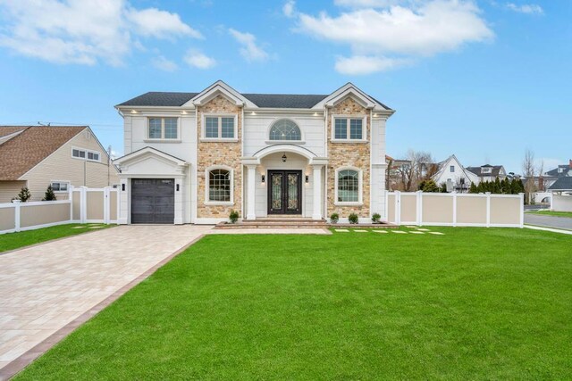 23 Grouse Ln, Levittown, NY 11756 - view of front of house featuring fence, driveway, french doors, and a front yard