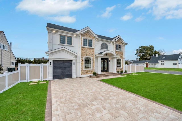23 Grouse Ln, Levittown, NY 11756 - view of front facade featuring fence, a front lawn, and decorative driveway
