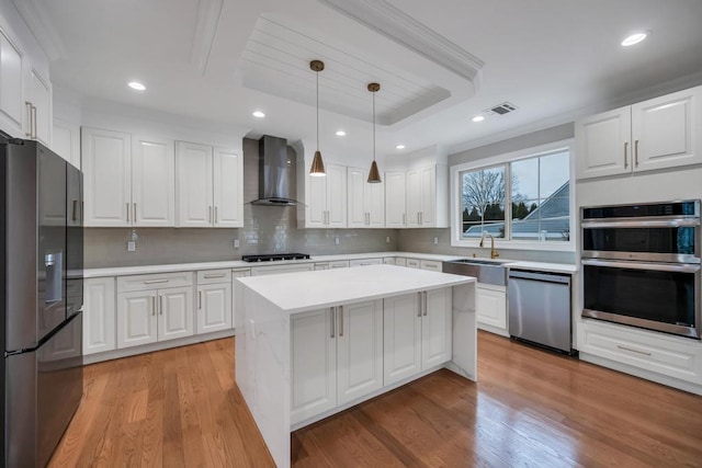 23 Grouse Ln, Levittown, NY 11756 - kitchen with stainless steel appliances, a sink, tasteful backsplash, wall chimney range hood, and light countertops