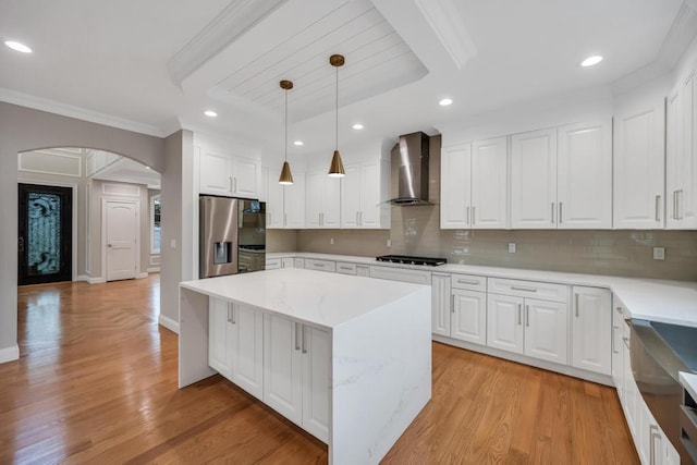 23 Grouse Ln, Levittown, NY 11756 - kitchen featuring wall chimney exhaust hood, arched walkways, backsplash, stainless steel refrigerator with ice dispenser, and ornamental molding