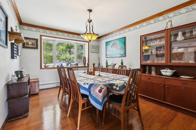 dining area with a baseboard radiator, crown molding, and dark wood finished floors