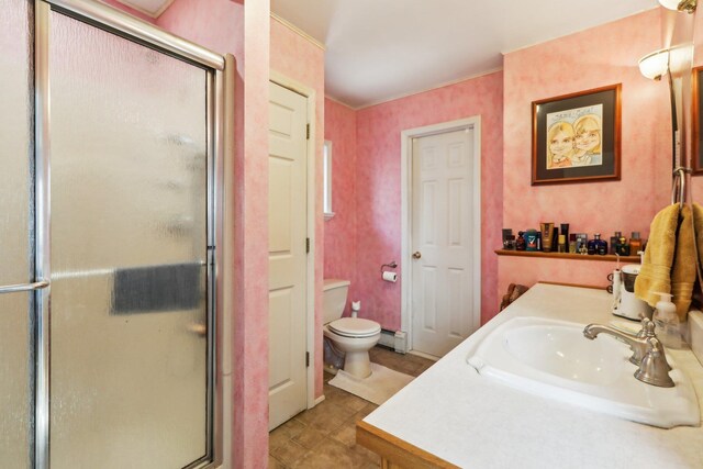 full bathroom featuring toilet, a baseboard radiator, vanity, tile patterned flooring, and a stall shower
