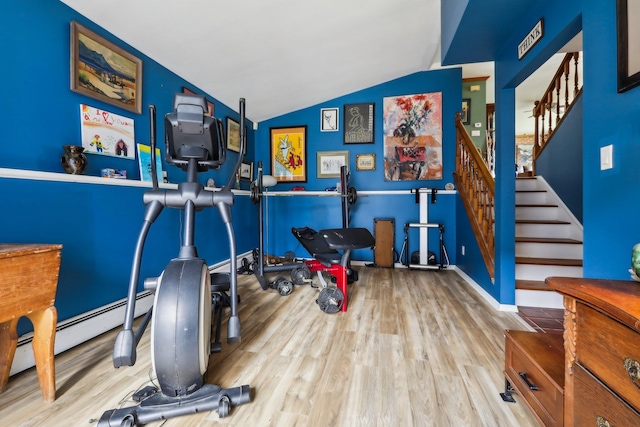 exercise room with wood finished floors and lofted ceiling