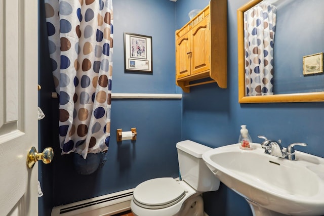 bathroom with a shower with shower curtain, a baseboard radiator, a sink, and toilet