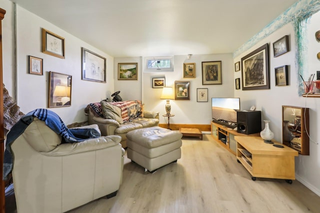 living area featuring baseboards and light wood-style floors