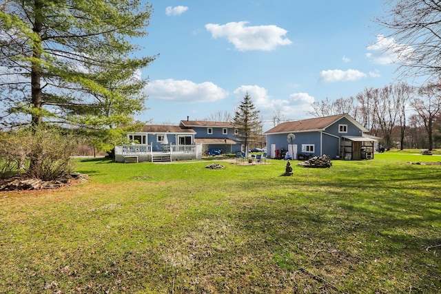 view of yard with a deck and a fire pit