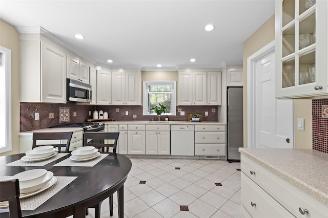 kitchen with a sink, appliances with stainless steel finishes, and white cabinets