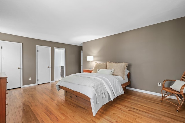 bedroom with baseboards and light wood-style flooring