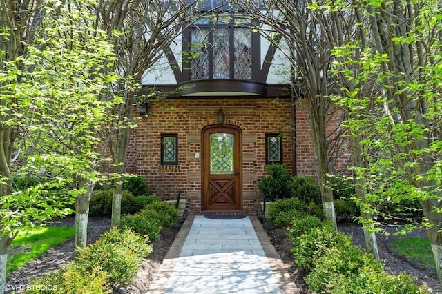 view of exterior entry with brick siding