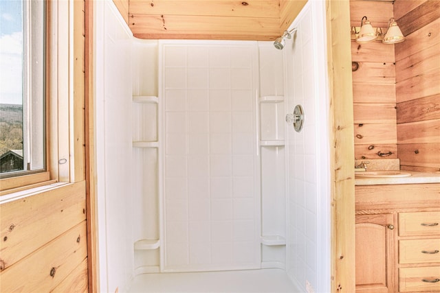full bathroom featuring wooden walls, vanity, and walk in shower