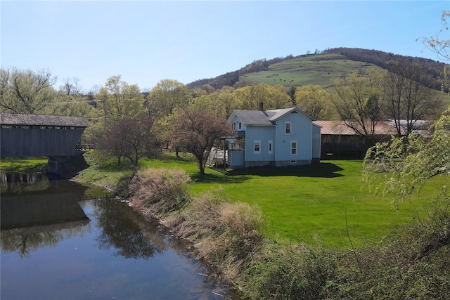 birds eye view of property with a water and mountain view