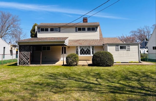 back of property featuring a yard and a chimney