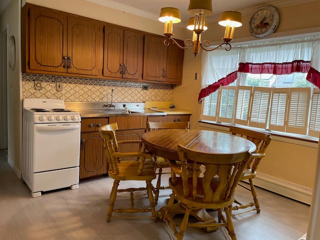 kitchen featuring electric stove, brown cabinetry, an inviting chandelier, stainless steel counters, and backsplash