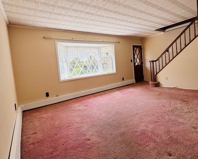 unfurnished room with a baseboard radiator, crown molding, stairway, and carpet flooring