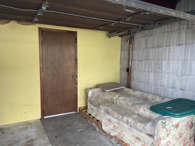 interior space with concrete block wall