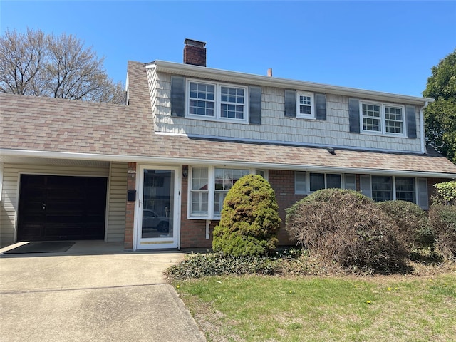view of front of house with a garage, roof with shingles, a chimney, and concrete driveway
