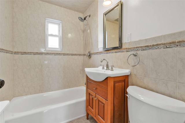 bathroom featuring vanity, tile walls, shower / bathing tub combination, and toilet