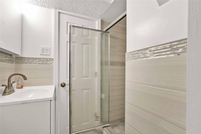 32-28 208th St, Bayside, NY 11361 - full bath with tile walls, a shower stall, vanity, tile patterned flooring, and a textured ceiling